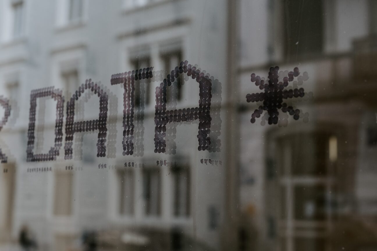 Window with street reflections and the word DATA printed on the window